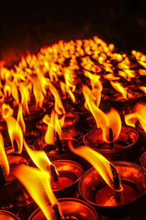 Close up of burning yak candles at Boudhanath Stupa, Kathmandu, Nepal 21-20