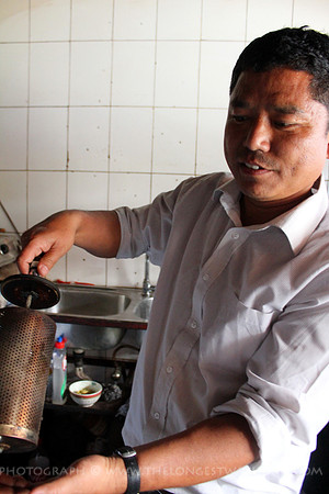 Vijara loading up his coffee roaster