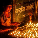 Woman with candles at Boudhanath Stupa - Kathmandu, Nepal