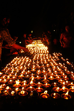 Lighting candles at night Boudhanath Stupa, Kathmandu, Nepal 26-25