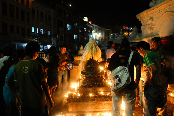 Tourists and locals lighting candles at Boudhanath Stupa, Kathmandu, Nepal 23-22