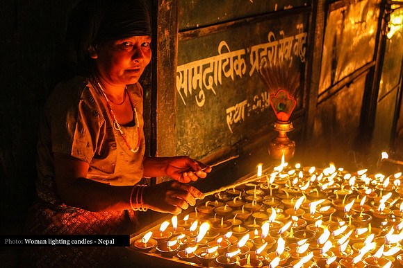 Woman with candles at Boudhanath Stupa, Kathmandu, Nepal 10-1